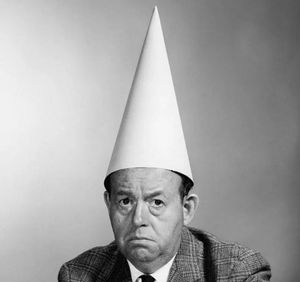 Man wearing dunce cap